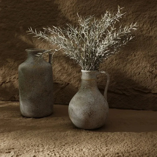 A beautifully styled living room with earthy textures, a ceramic vase, and natural accents that tie the space together