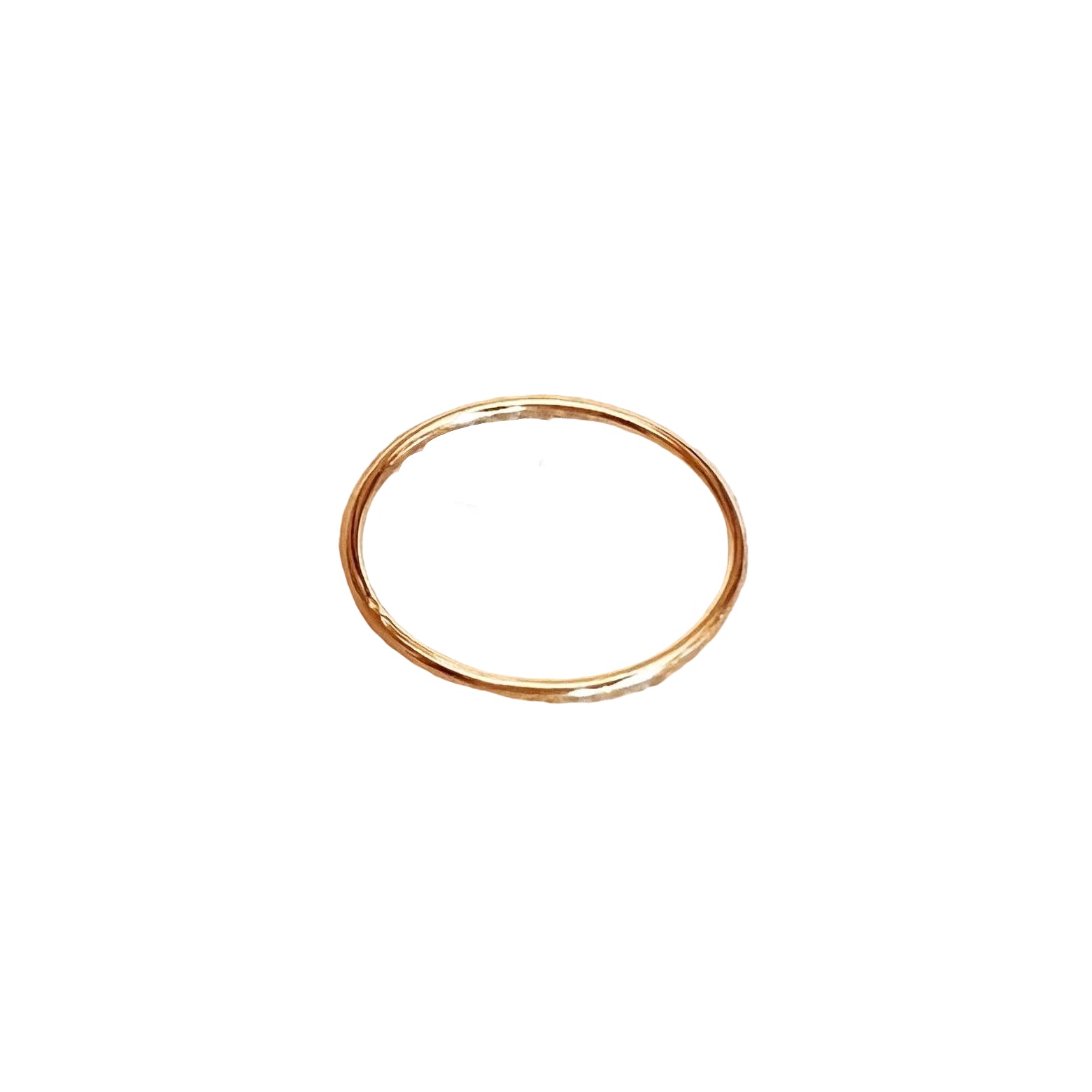 Gold ring on a beige textured fabric background
