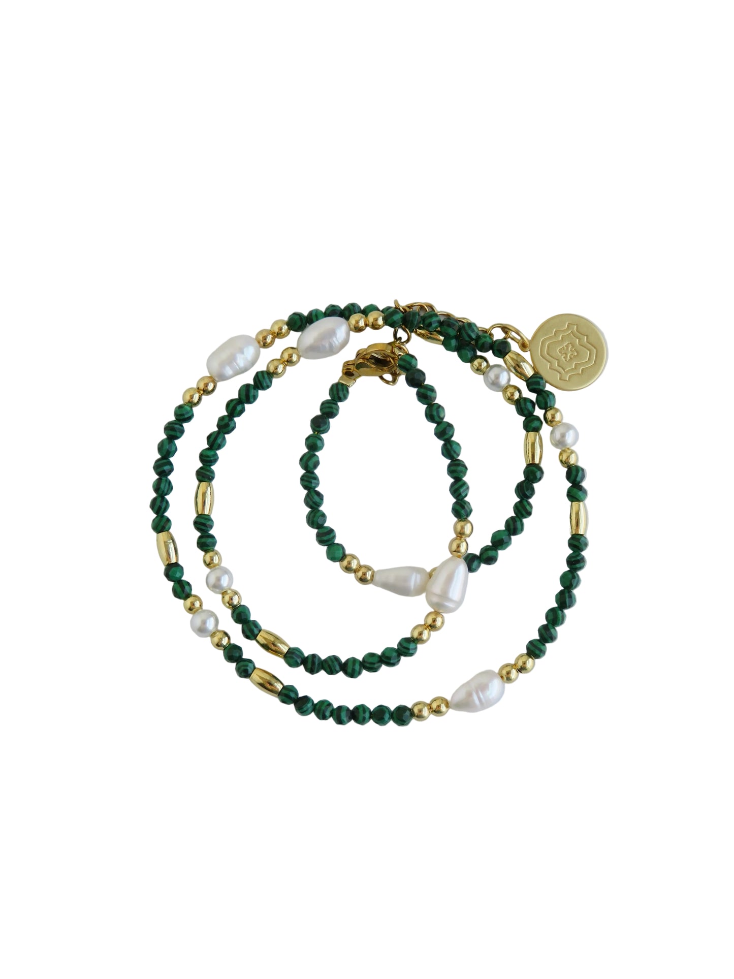 Green beaded necklace with gold accents on a light gray background