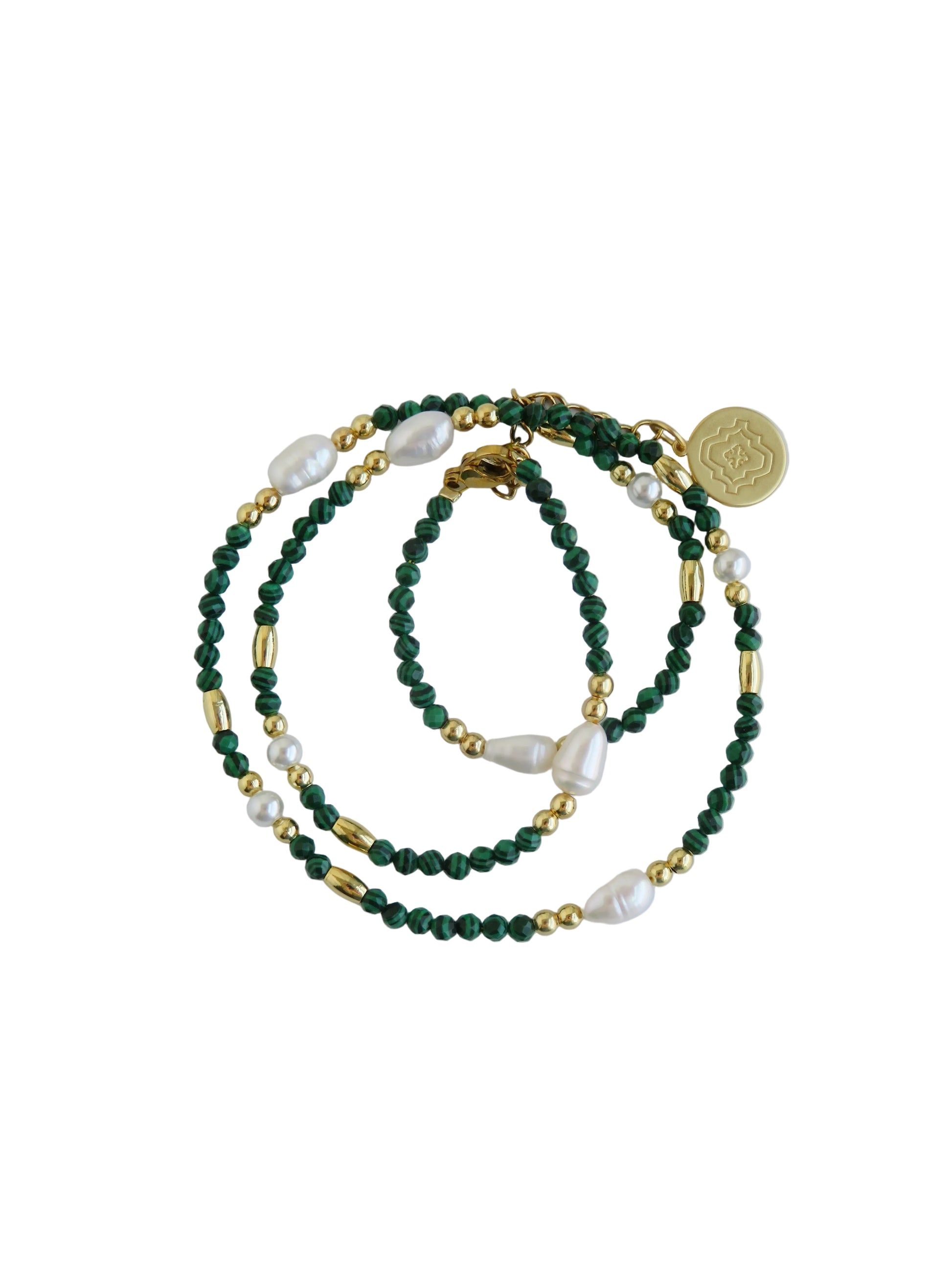 Green beaded necklace with gold accents on a light gray background