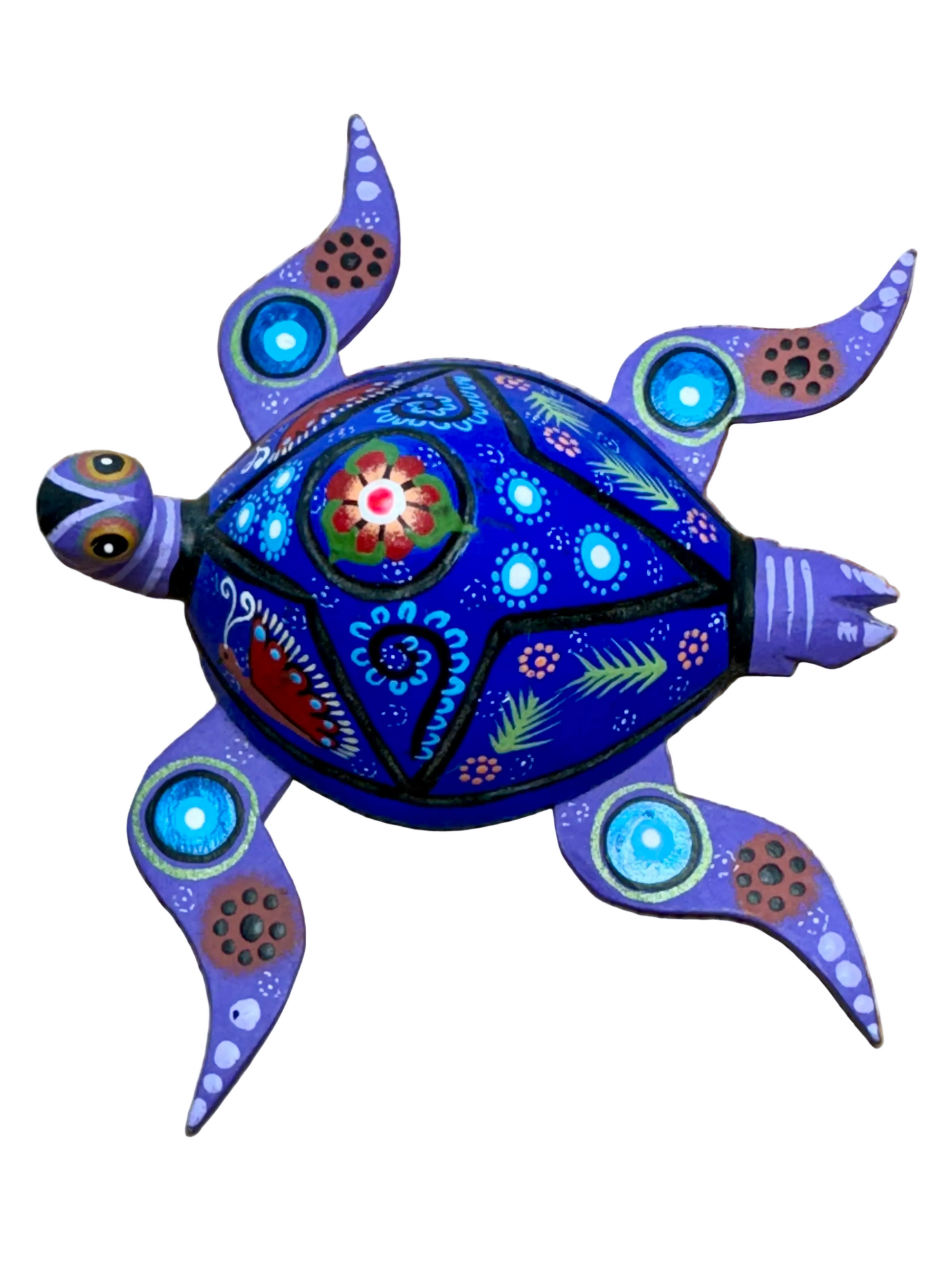 Decorative turtle ornament with colorful patterns on a wooden surface