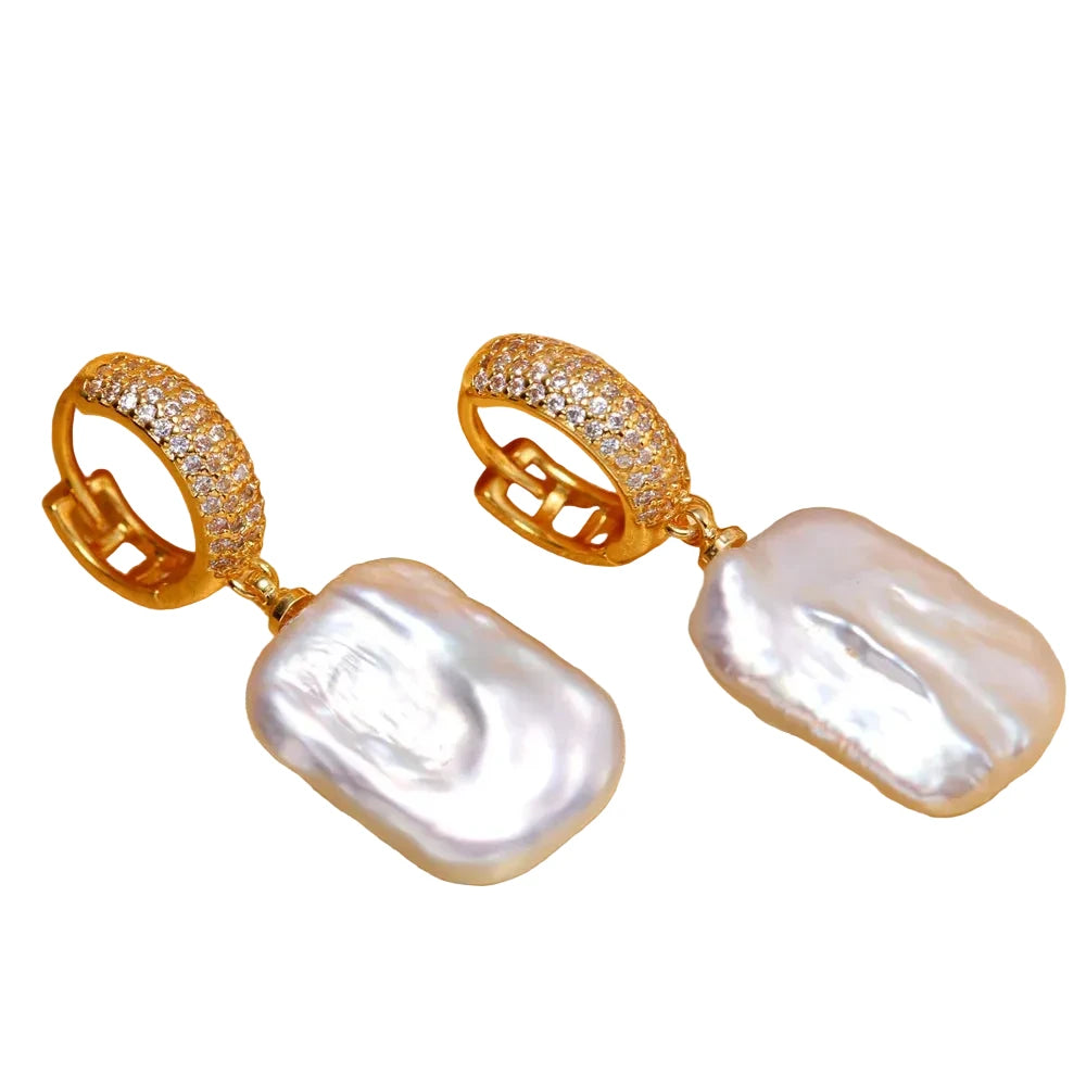 Gold earrings with large white pearls 