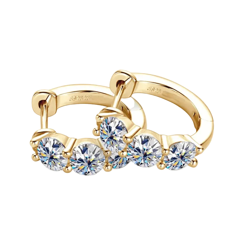 Gold ring with clear gemstones on a white background