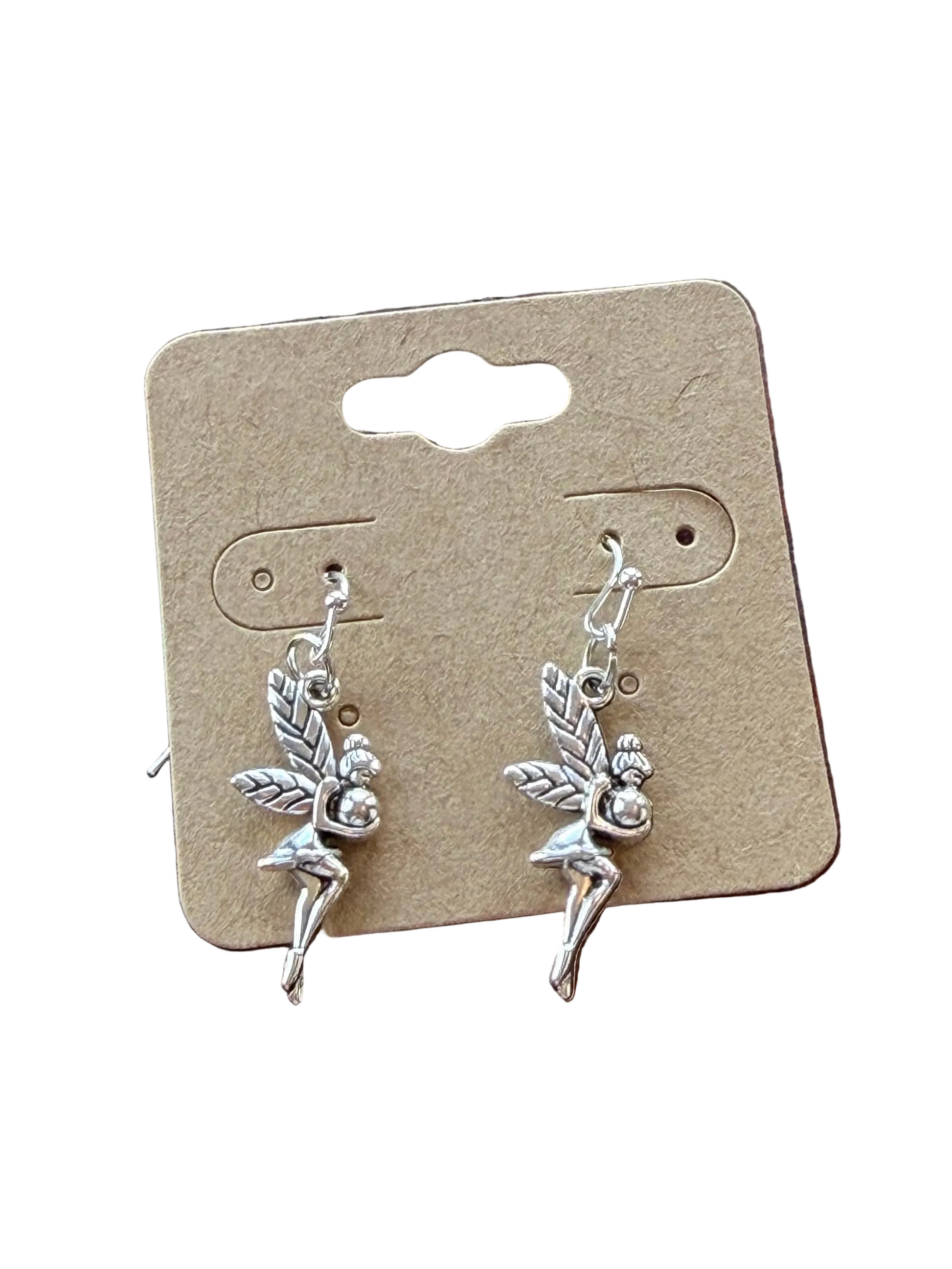 Pair of silver fairy earrings on a cardboard backing with a natural wood background