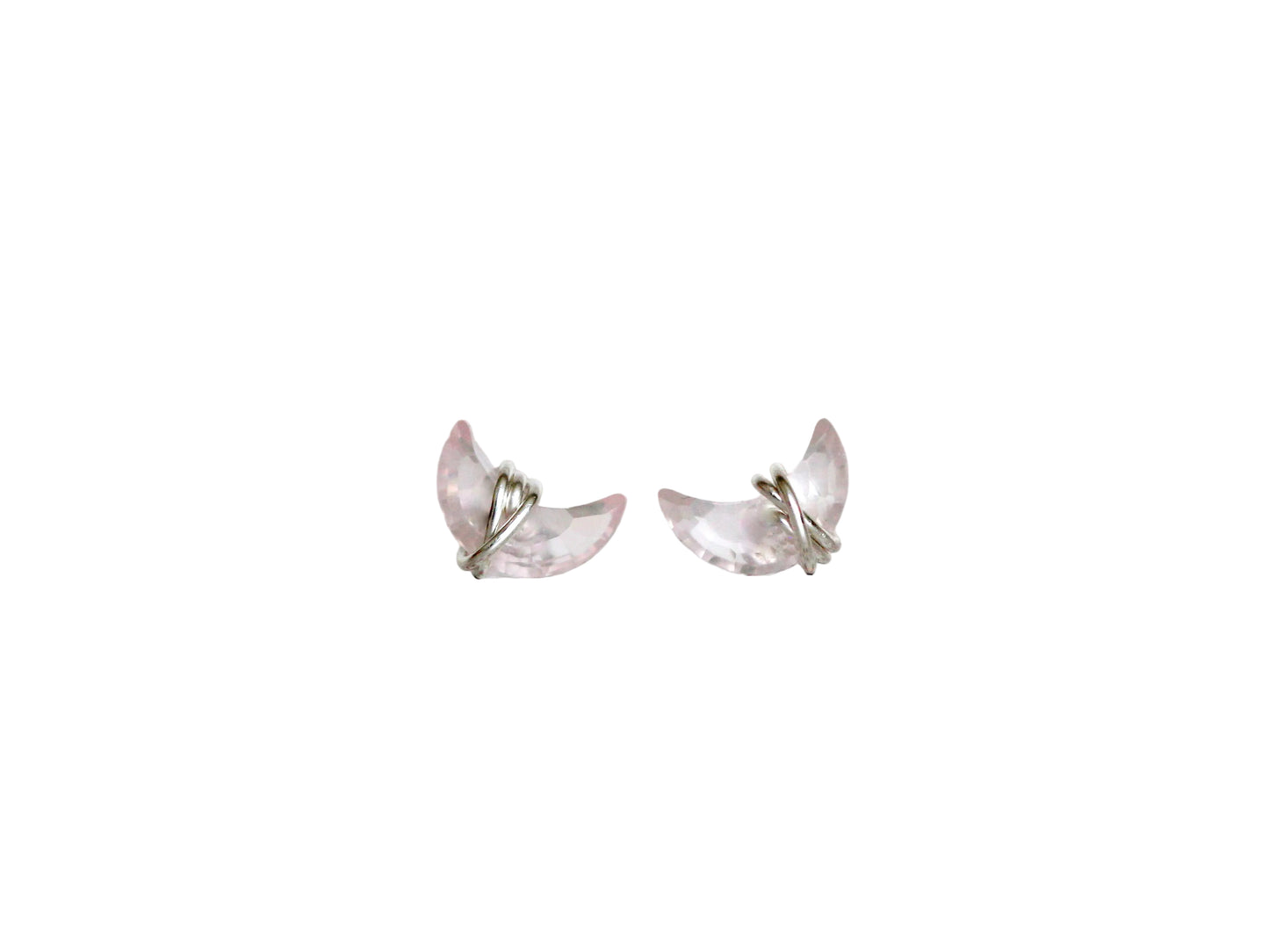 Butterfly-shaped earrings on a light fabric background