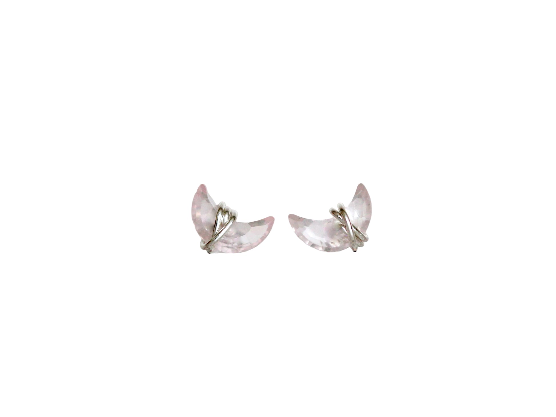 Butterfly-shaped earrings on a light fabric background