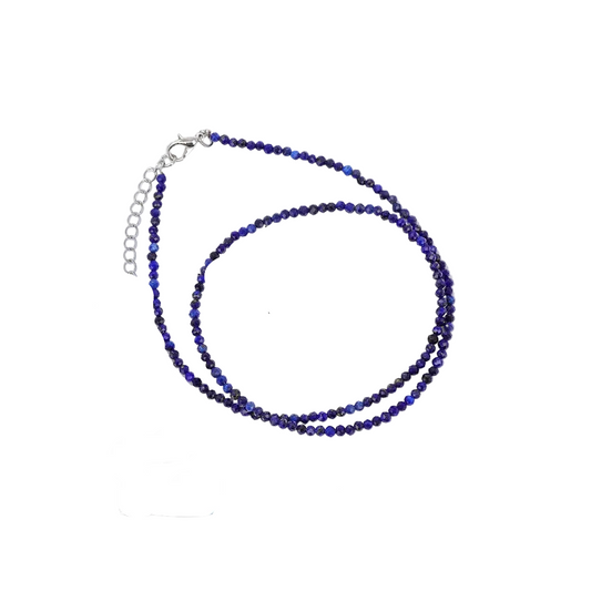 Lapis Lazuli necklace on a card with information about the stone and its properties.