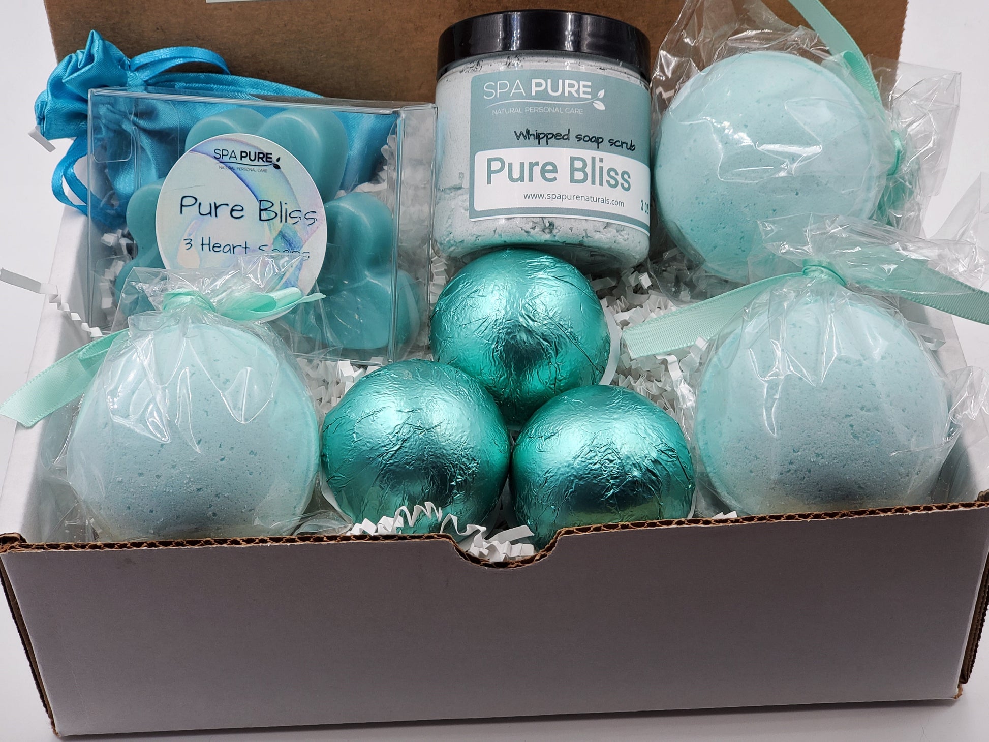 Box of bath bombs and a jar labeled 'Pure Bliss' with 'Spa Pure' branding.