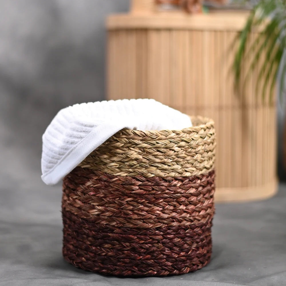 Woven basket with a white towel on a gray surface