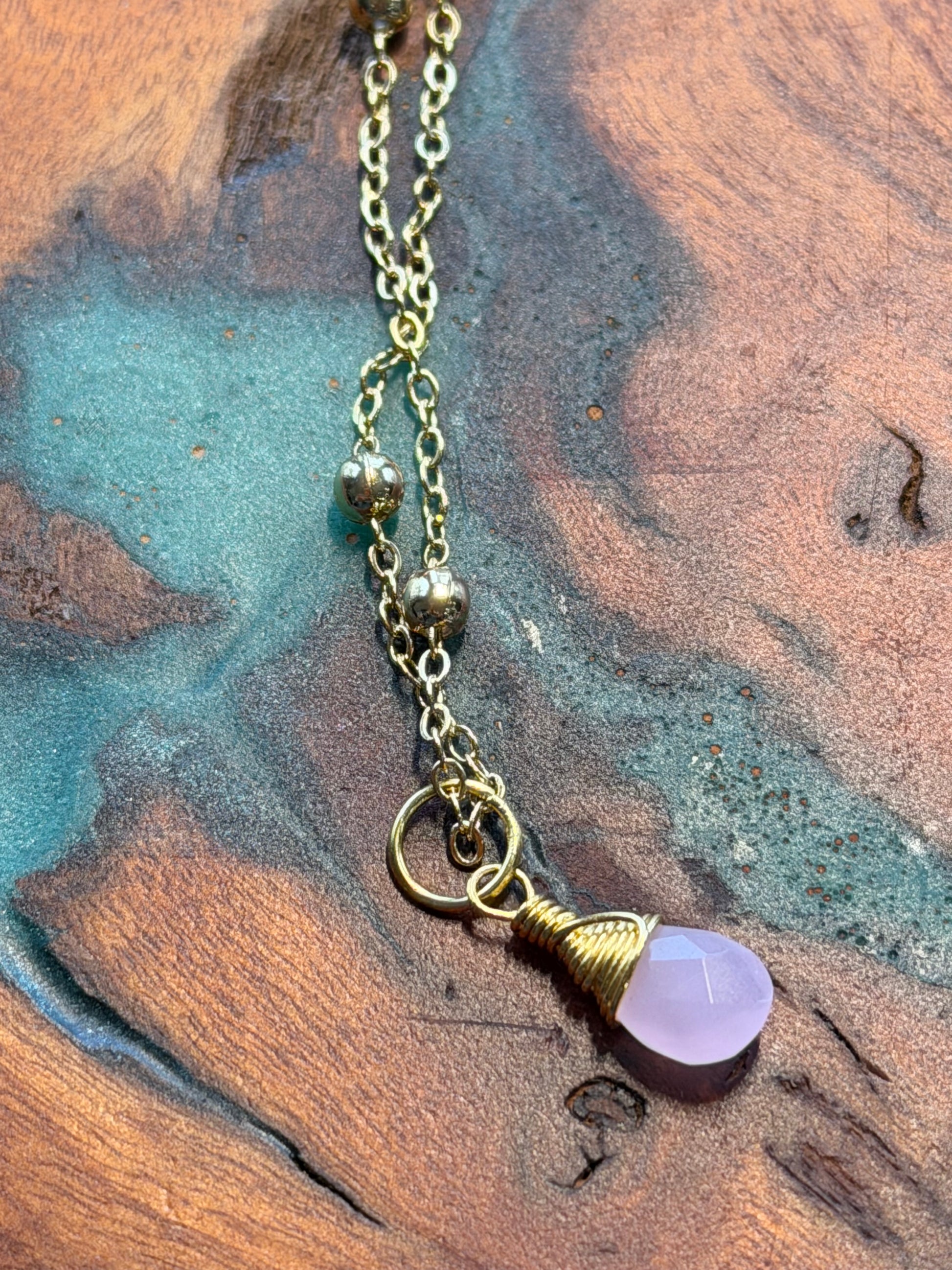 Gold necklace with a rose quartz gemstone pendant