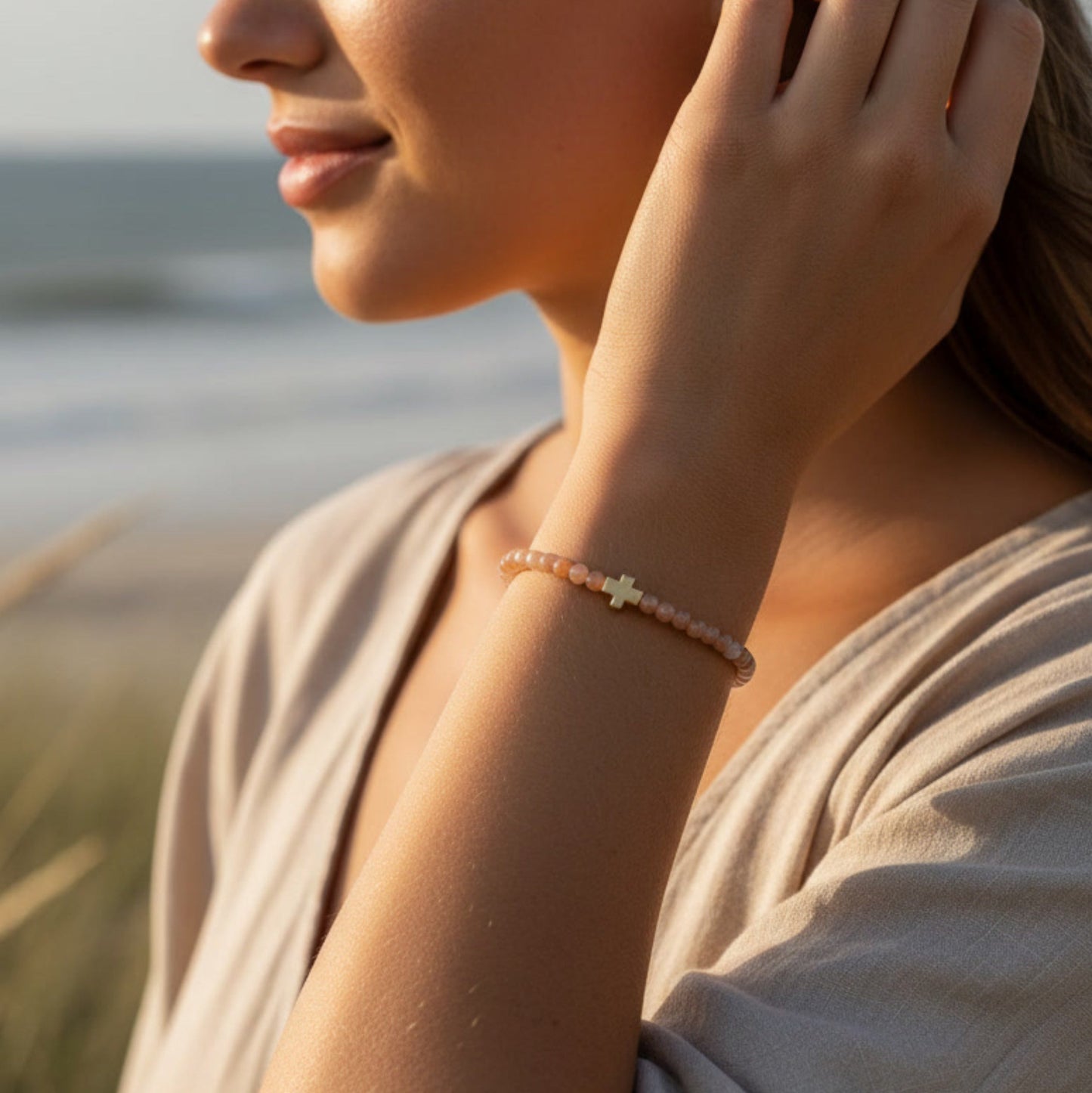 Woman wearing a bracelet with a blurred beach background