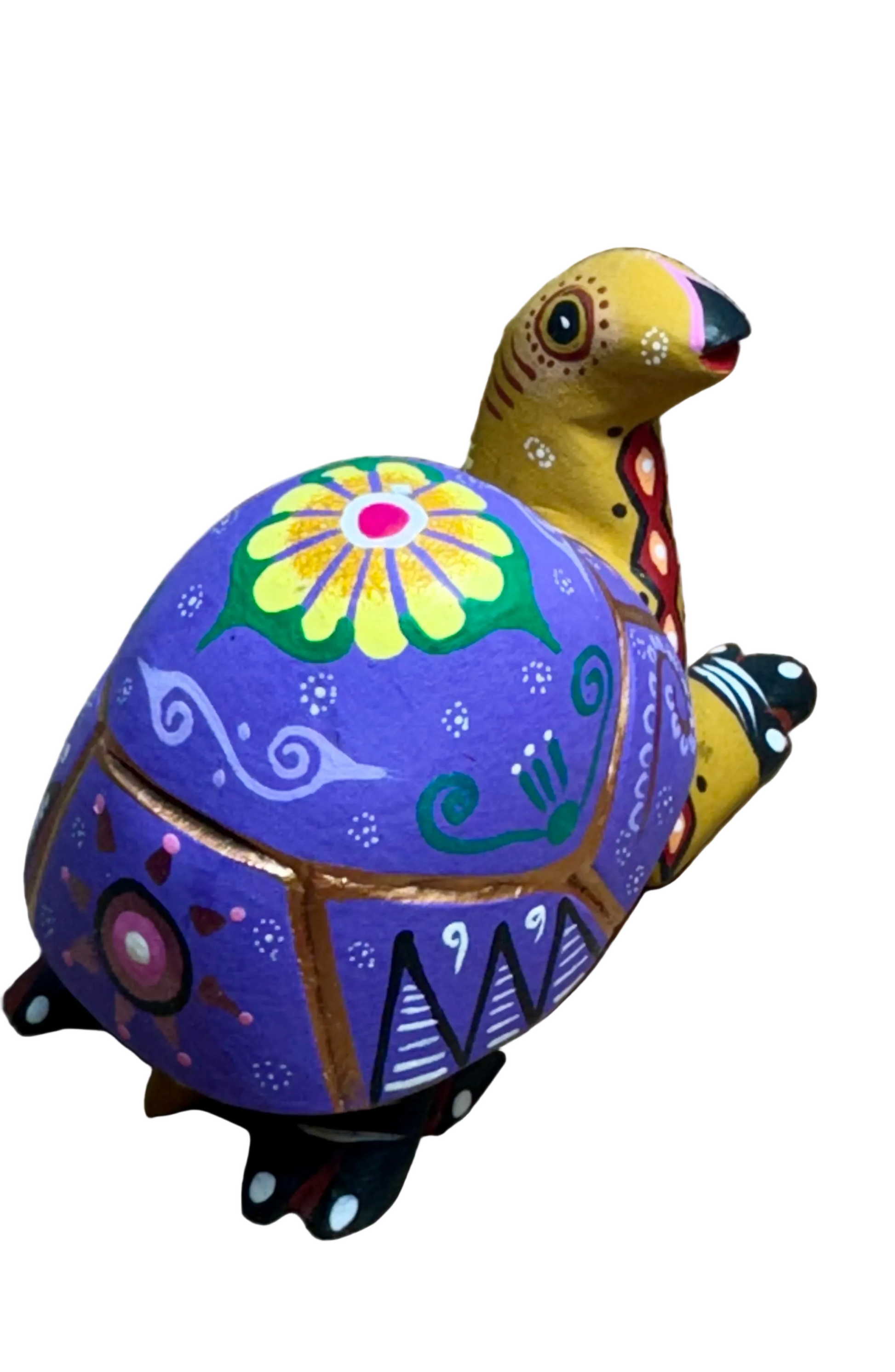 Colorful turtle figurine with floral design on a wooden surface