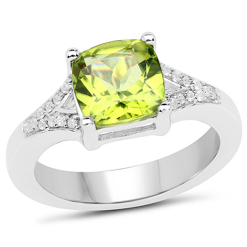Silver ring with a green gemstone and diamond accents on a white background