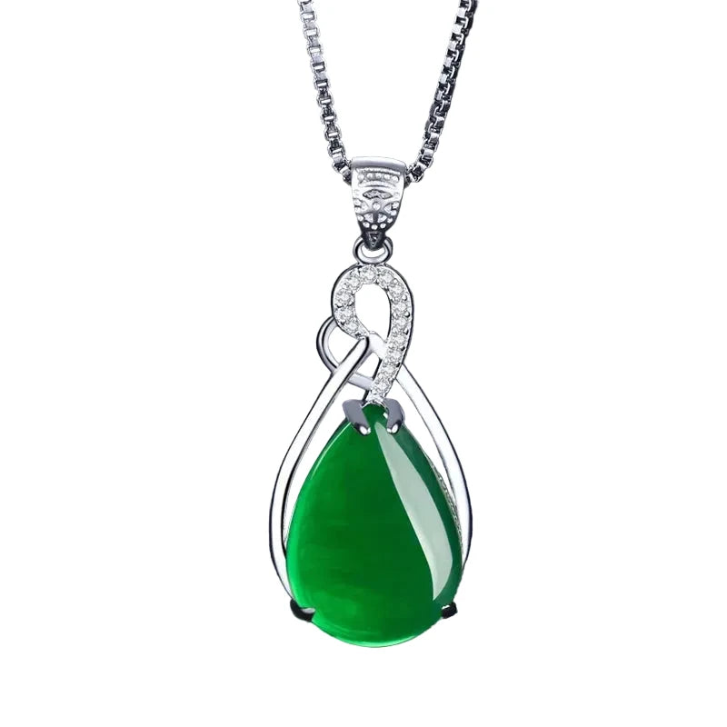 Emerald  teardrop pendant on a silver chain against a white background