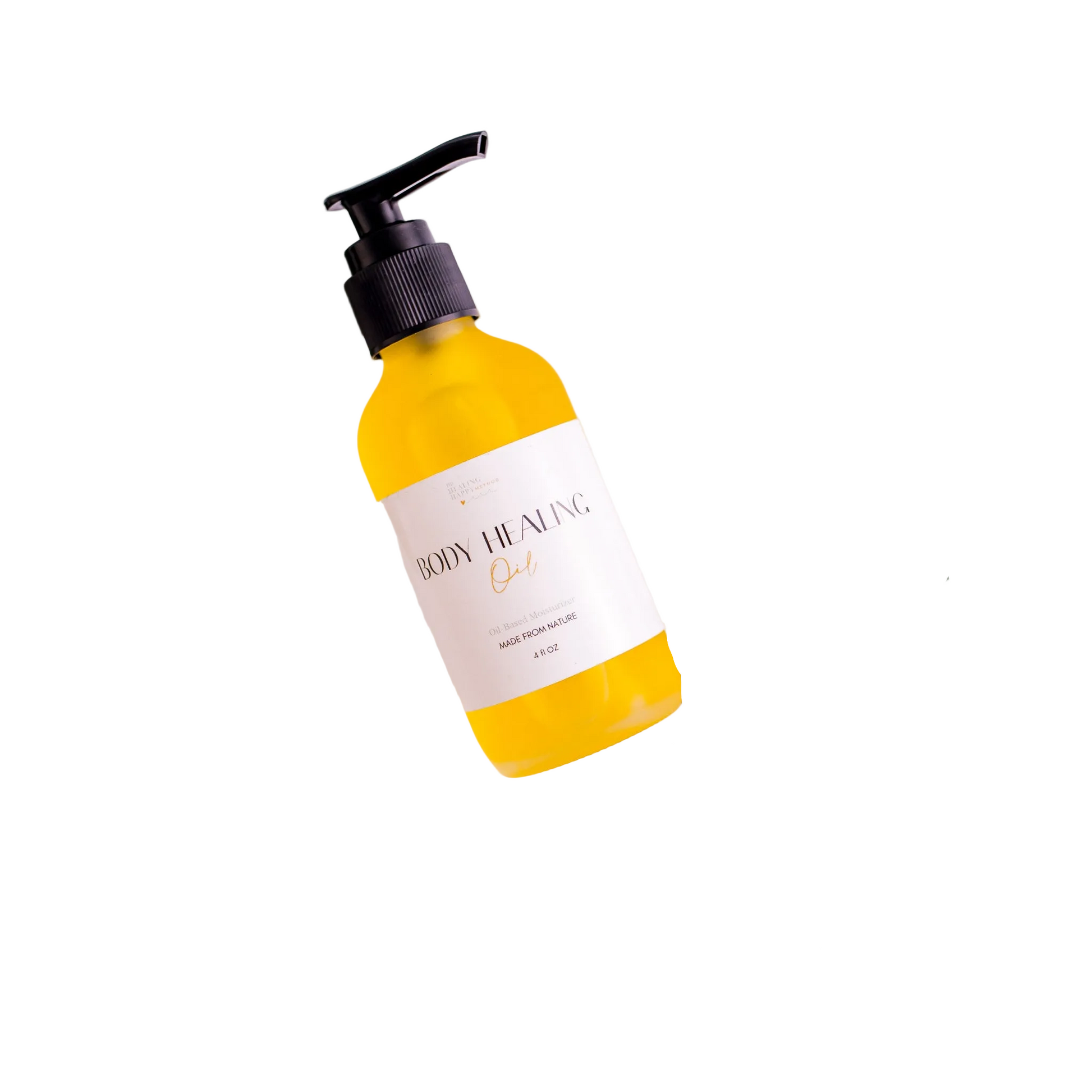 Yellow and white bottle labeled 'Body Healing Oil' surrounded by eucalyptus leaves on a light background