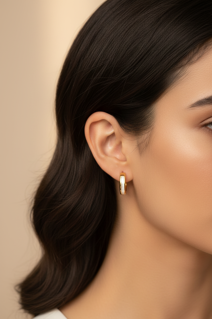 Latina model wearing 16K gold filled shell pearl huggie earrings
