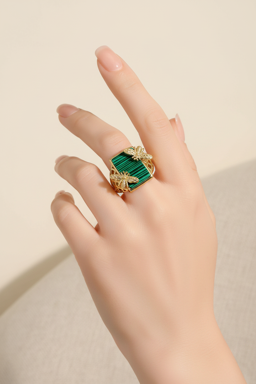 Model wearing gold bee malachite rectangle statement ring in 14k gold-filled band