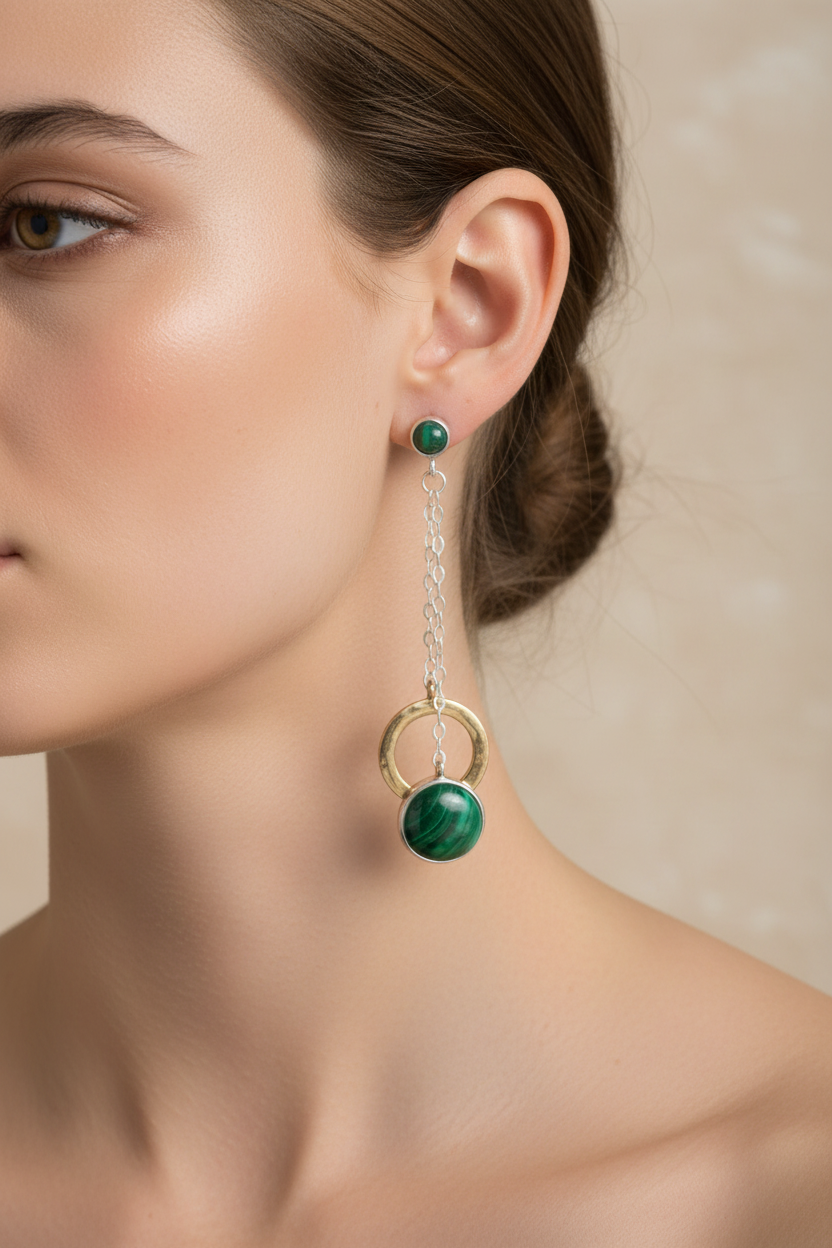Model wearing malachite and two-tone sterling silver and bronze circle dangle earrings