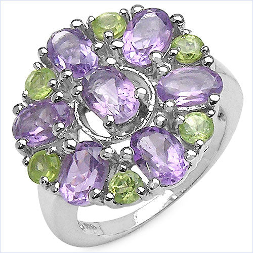 Ring with purple and green gemstones on a white background